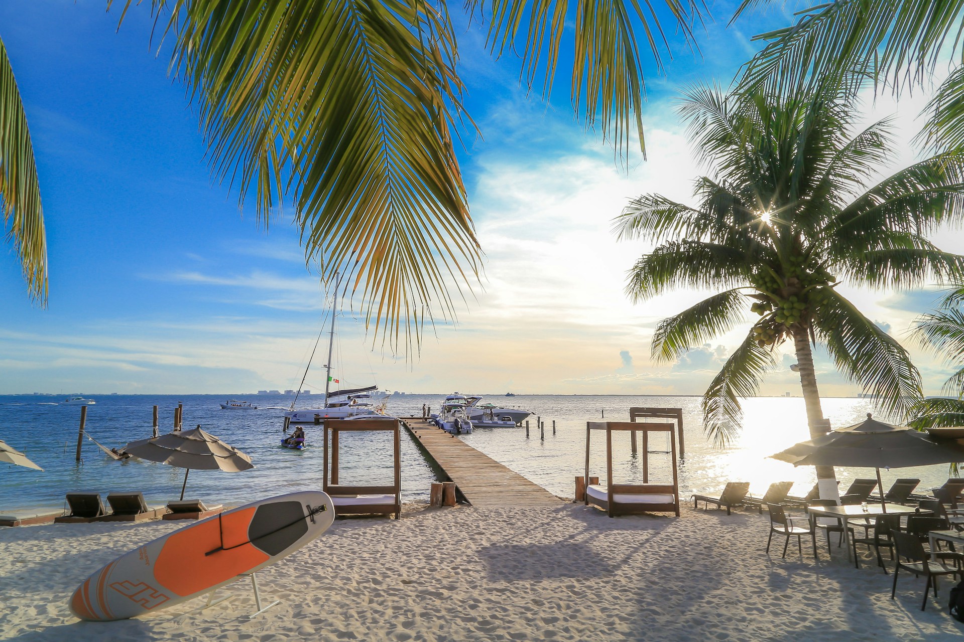 View of the ocean from beach on Isla Mujeres with dock and fishing boats