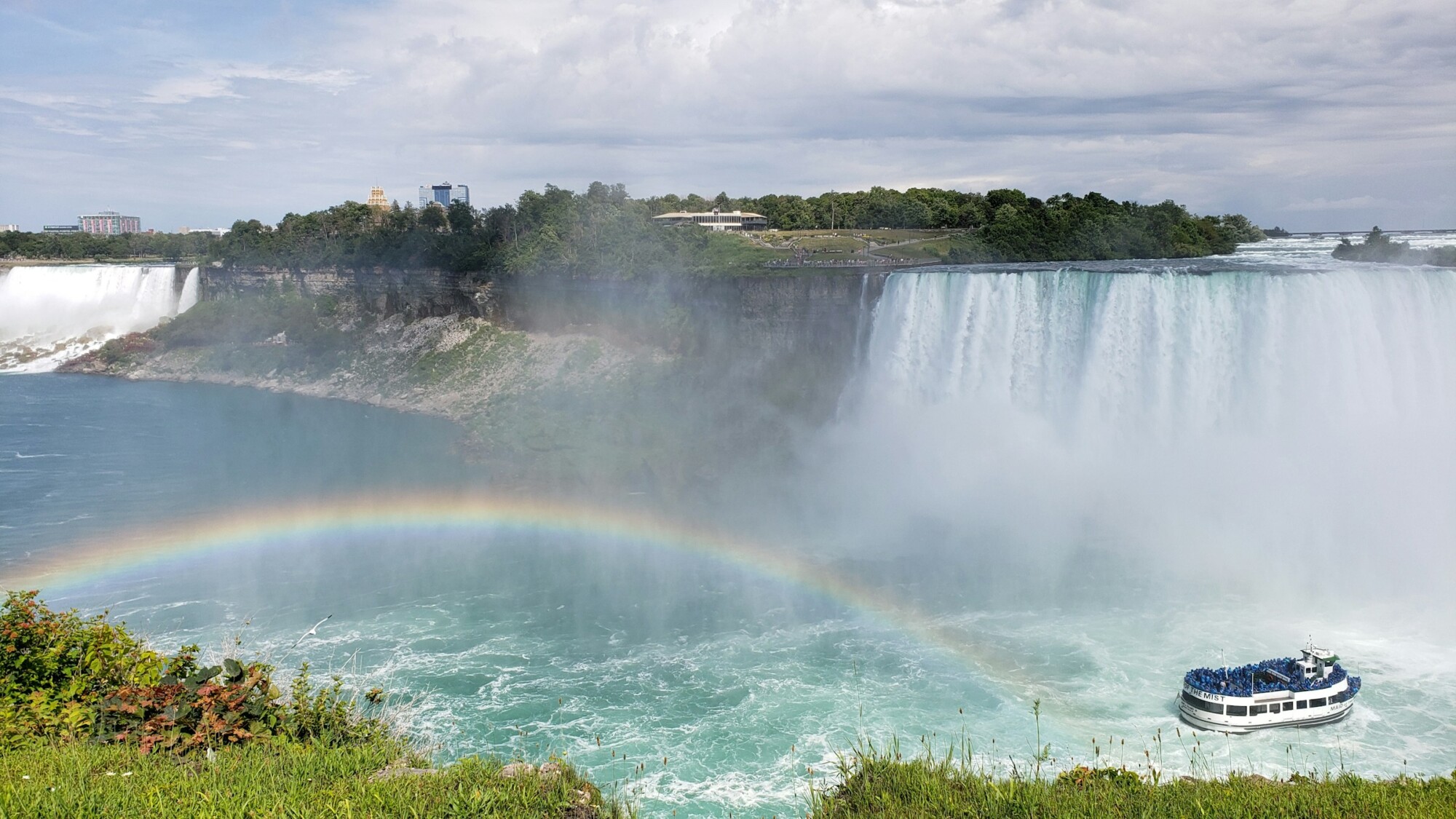 Niagara Falls with rainbow and cruise boat