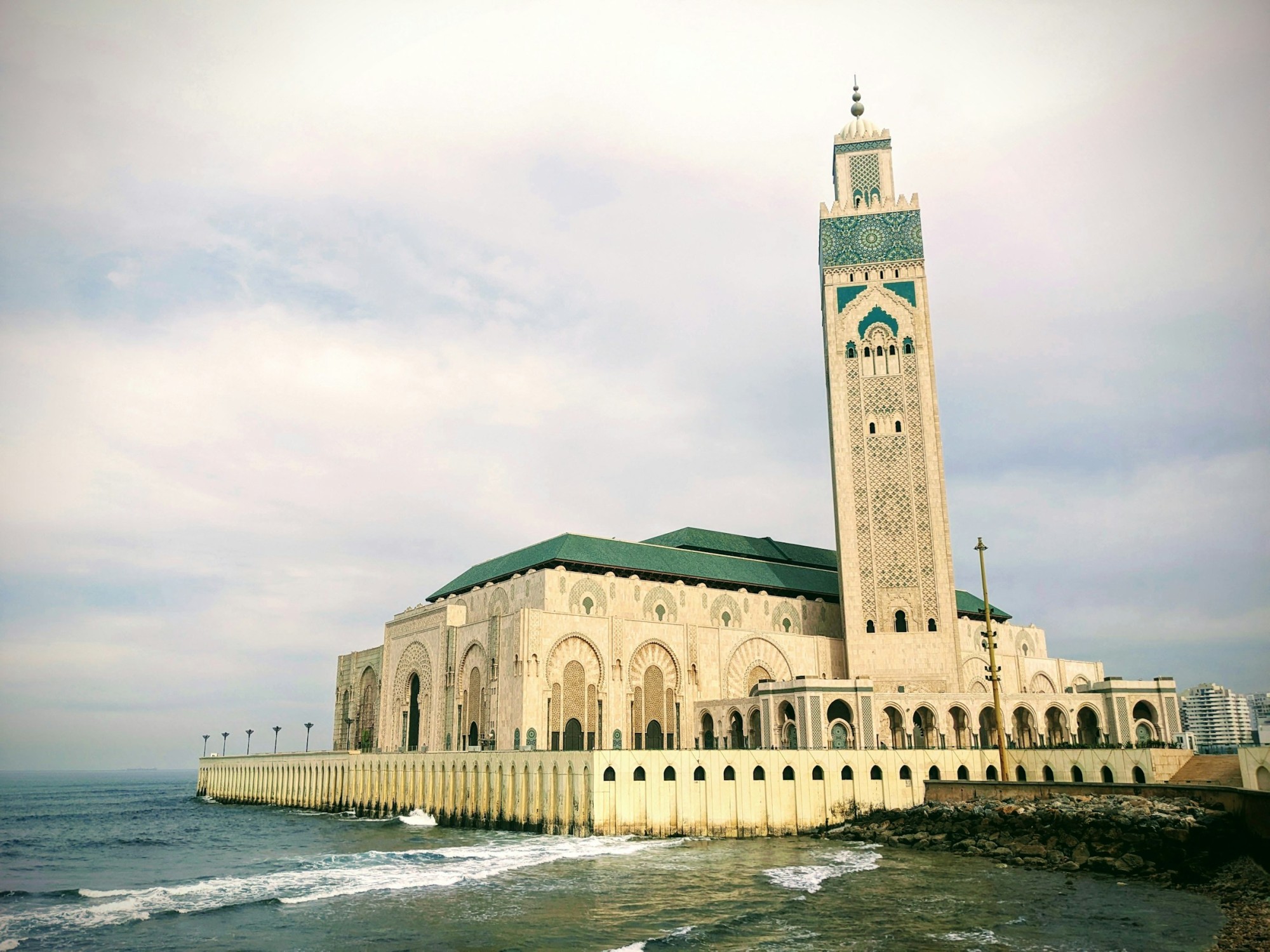 Hassan II mosque in Casablana with Atlantic Ocean in foreground